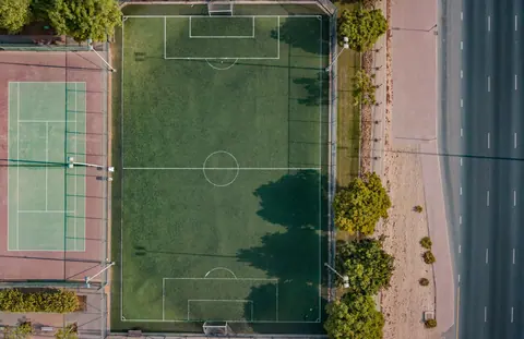 Aerial view of a multi-sport court beside a playing field