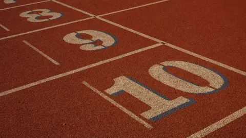 Lane numbers eight, nine and ten painted on a synthetic athletics track